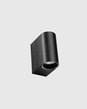 Black cylindrical light fixture on a white background