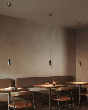 Dainty Brass Italian Single Pendants positioned over three tables in a beige and brown restaurant