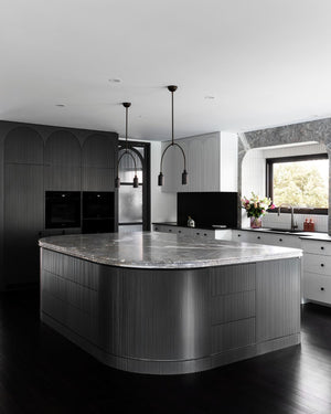 Dainty Brass Italian Two Light Pendant in a modern black a white kitche
