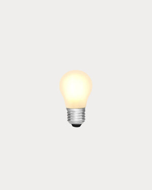 A single glowing light bulb with a warm yellow glow and a silver screw base, centered on a plain light gray background.
