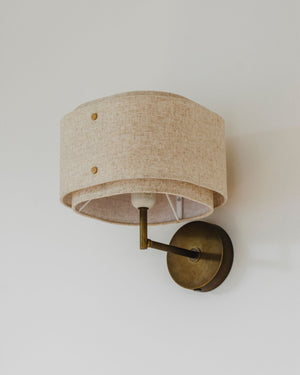 Double fabric wall sconce on a white wall
