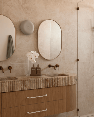 Bathroom vanity with a ceramic Eclipse wall sconce from Studio Enti