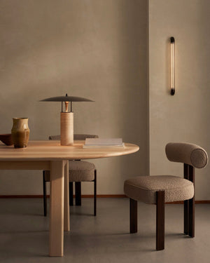Dining area with wooden table and Elemental Disc Table Lamp in a minimalistic setting
