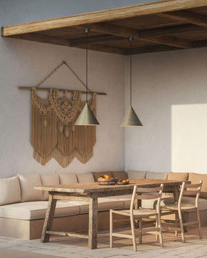 Exterior Pre-Aged Brass Cone Pendant over a dining table on a coastal terrace 
