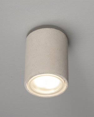 A modern cylindrical ceiling light with a textured clay finish.