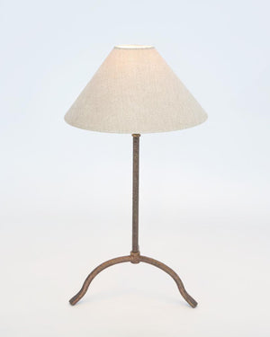 Farmhouse bronze table lamp with warm lighting against a white studio background
