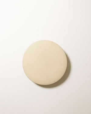 Small ceramic disc wall light in bone finish