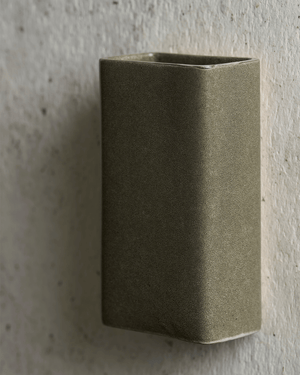 Green rectangular wall light on a textured light
