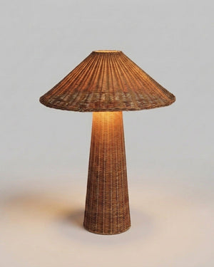 Handwoven rattan table lamp with warm light on