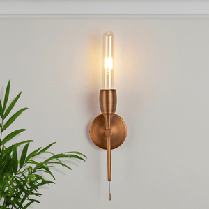 Modern Bronze Torch Wall Light on a wall lit up