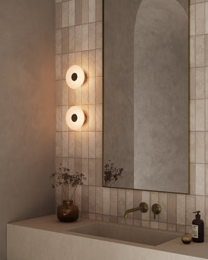 Bathroom interior with a sink, mirror, and wall lights.