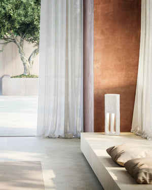 Italian Ceramic Floor Lamp illuminated on low platform in Mediterranean interior with sheer curtains and olive tree beyond