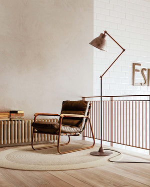 Pre aged industrial adjustable floor lamp in a minimalist reading nook