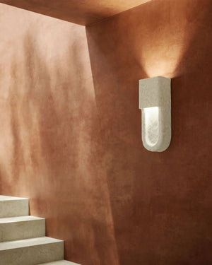 Italian Organic Ceramic Uplight on terracotta plaster wall casting warm upward glow above stone staircase