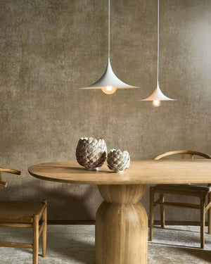Large white curved conical pendant light suspended above wooden dining table in contemporary space