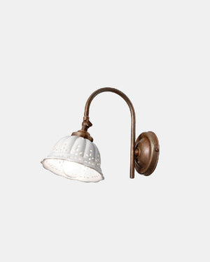 Curved arm aged brass wall light with a white ceramic shade