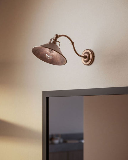 Brass Curved Fixed Arm Wall Light displayed over a mirror