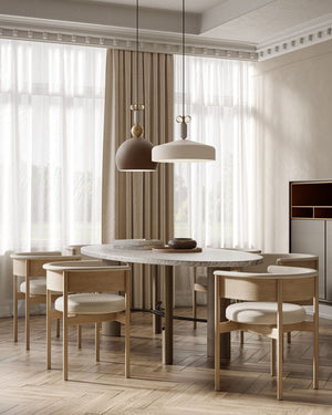 Matte white aluminium narrow and brown round pendant lights over a dining table in a classic yet modern room