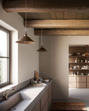 Two medium size pre aged brass pendant in a farmhouse style kitchen