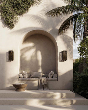 Outdoor Mediterranean Perforated Brass Wall Lights outside on both side of a sofa