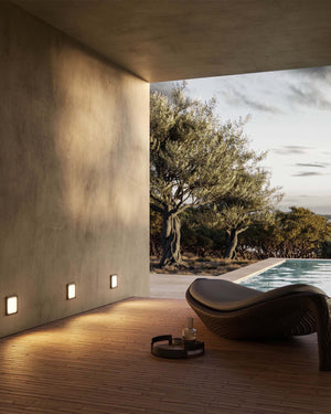 Outdoor Antique Brass Step Light near a pool on a covered deck