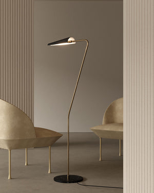 Modern floor lamp with a curved design in a minimalistic room.