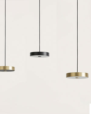 Three pendant lights with gold and black finishes on a white background