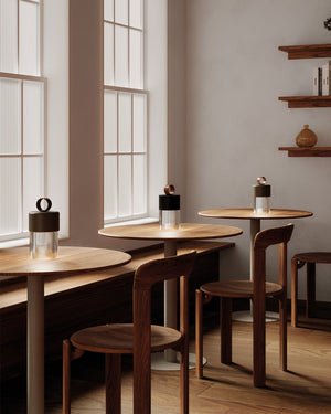 Modern interior with wooden tables with Modern Ridged Glass Portable Lamp on top