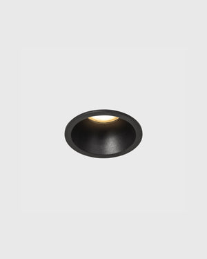 Small fixed downlight in black finish on grey background