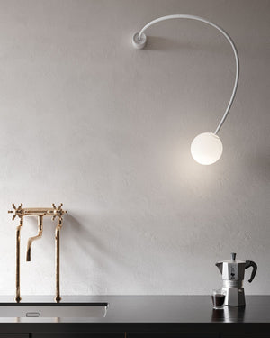 Minimalist Flexible Arm and Orb Wall Light In a kitchen 