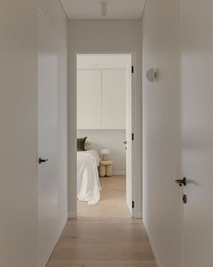 Dome wall light styled in a minimalist hallway