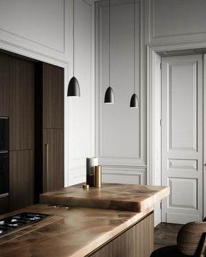 Modern kitchen with wooden countertops and pendant lights.