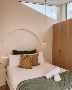 Ceramic pendant styled in a modern coastal bedroom