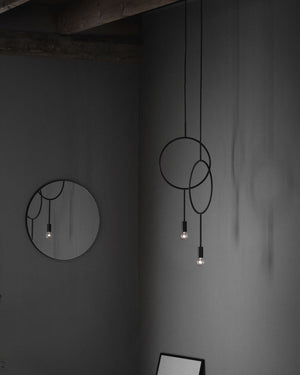 Nordic Circle Pendant fixture with circular design on a gray wall.