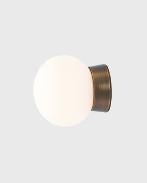 Wall-mounted light fixture with a brass finish on a white background