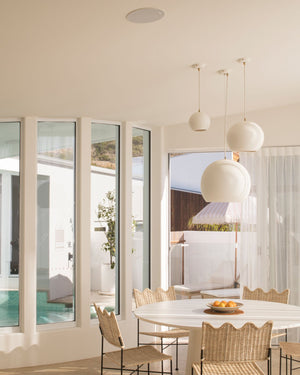 Modern dining room with orb pendants installed above dining table