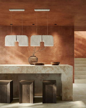 Organic Ceramic Pendant Light pair suspended above stone kitchen island with wooden stools in terracotta interior