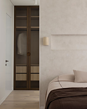 Ceramic wall light styled in a minimalist bedroom