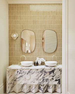 Eclectic scultpural wall light styled in a luxury bathroom
