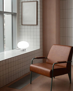 Ovate glass table lamp with a frosted white glass and chrome base