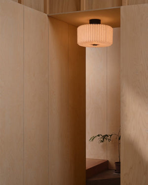 Pleated Fabric Ceiling Light mounted in plywood-panelled hallway casting warm diffused light downward