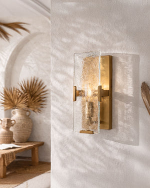 Glass and brass panel wall light in a modern mediterranean space