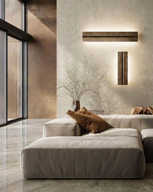 Rectangular Industrial Wall Light installed horizontally and vertically in antique iron above sofa on textured plaster wall