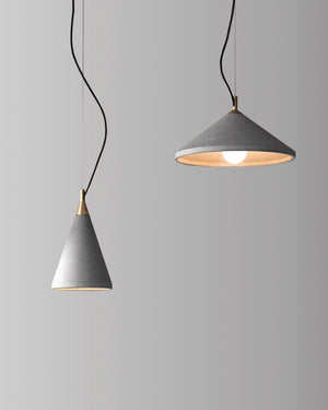 Two concrete pendant lights on a grey background