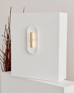 Brushed brass finish of Reflector wall sconce light mounted on textured wall