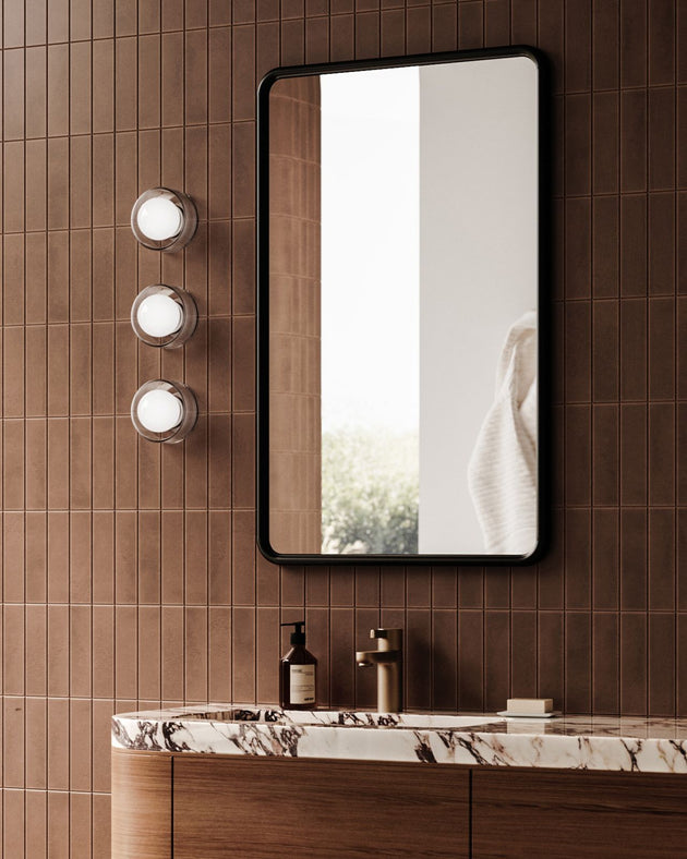 Ribbed Glass Framed Orb Wall Light Styled in Contemporary Bathroom