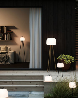 Modern indoor and outdoor setting with floor lamps in a living room and garden - Lighting Collective 