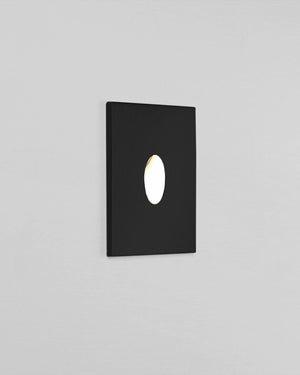 Black square wall light fixture on a gray background
