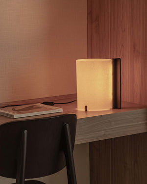 Timber base table lamp with papyrus shade on table