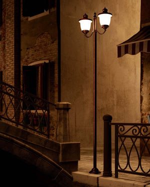 Traditional Italian Double Head Bollard Light in a street next to a bridge